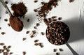 Ground espresso coffee and whole beans compared side by side