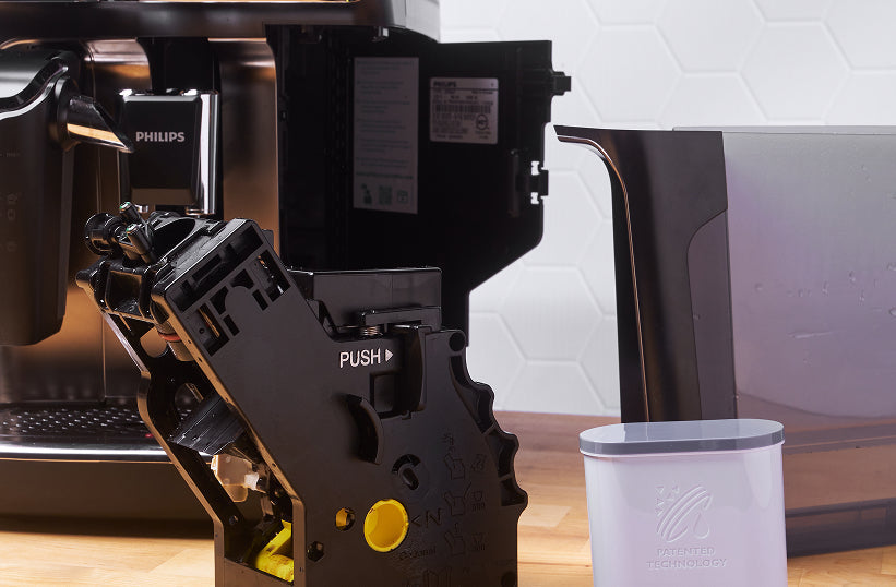 A Philips superautomatic espresso machine with its brew group removed for cleaning