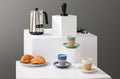 DeLonghi milk frother, espresso tamper, and notNeutral espresso cups on a coffee bar display