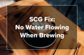 An overhead shot of a latte in a dark cup on a wooden tray with text reading SCG Fix: No Water Flowing When Brewing