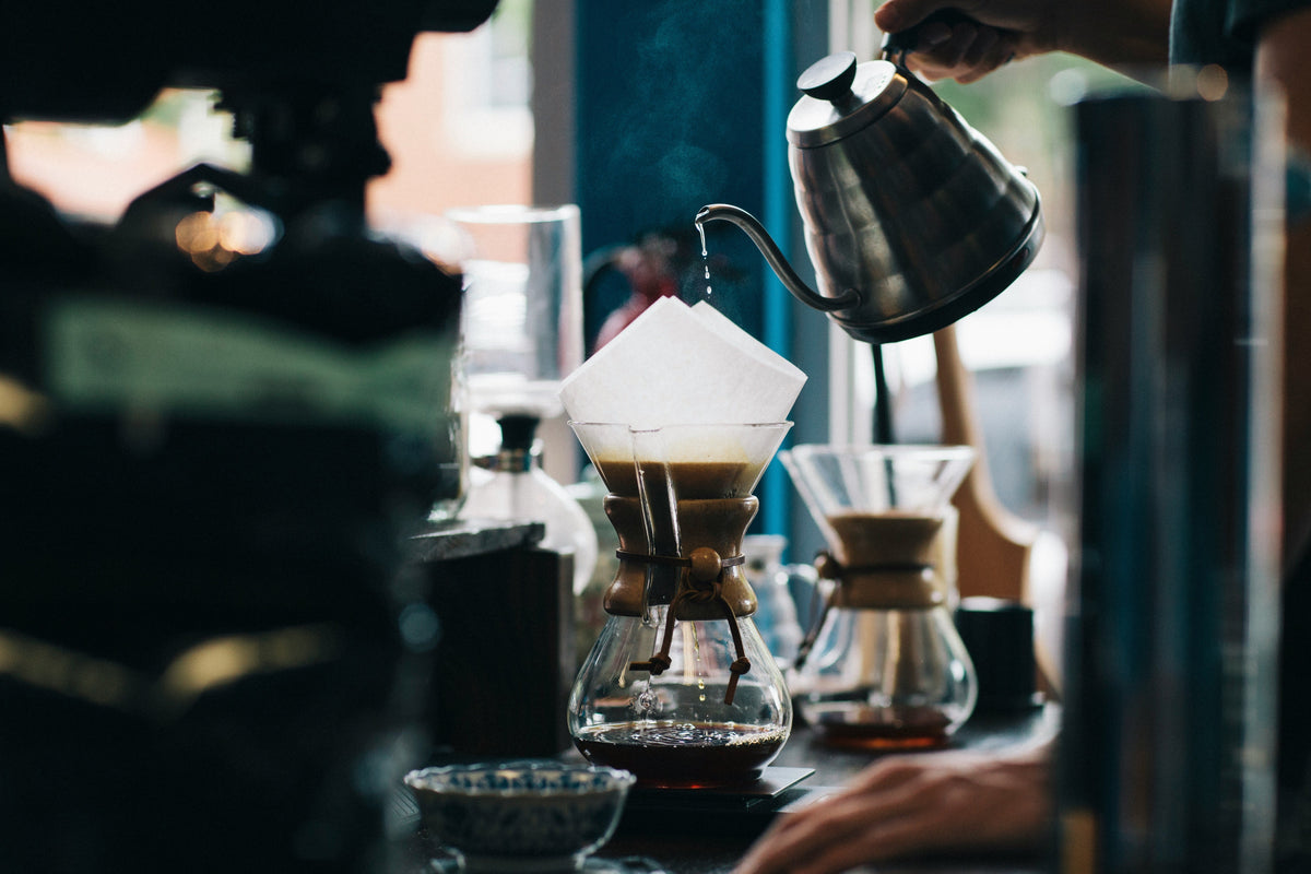 Water being poured over Chemex coffee brewer 