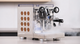Rocket Espresso Appartamento espresso machine in stainless steel with copper side panel cutouts on a kitchen countertop